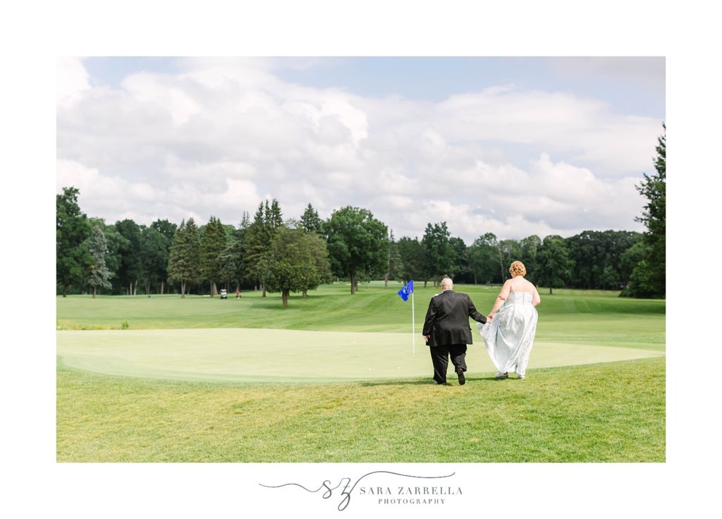 couple walks by golf course at Kirkbrae Country Club