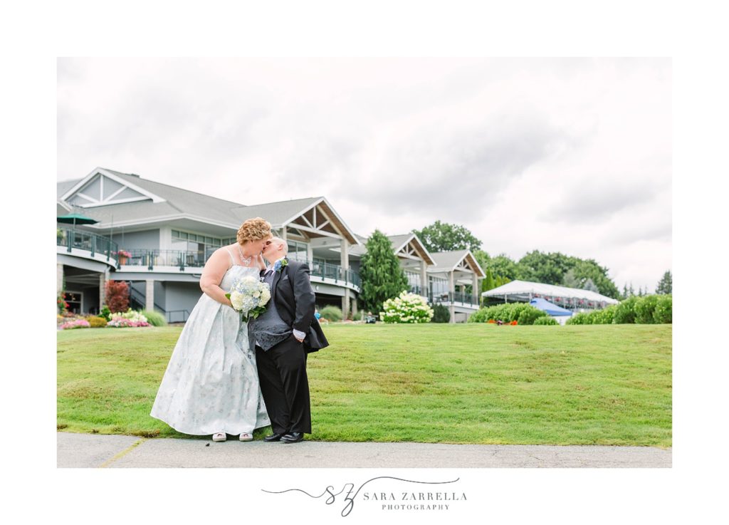 newlyweds kiss outside of Kirkbrae Country Club