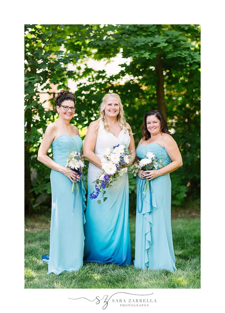 bridesmaids in teal gowns pose in Franklin MA