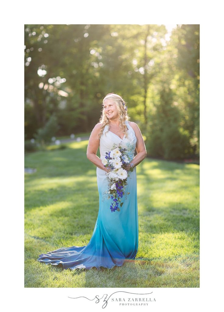 bride poses in ombre dress during sunset