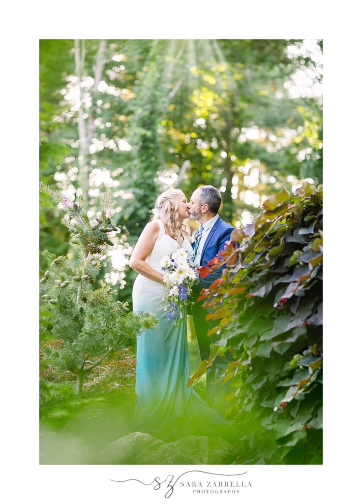 bride and groom kiss during intimate backyard wedding