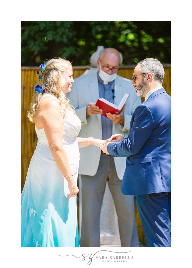 bride and groom exchange vows in intimate backyard wedding