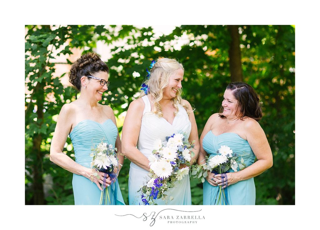 bride and bridesmaids laugh together during photos at intimate backyard wedding