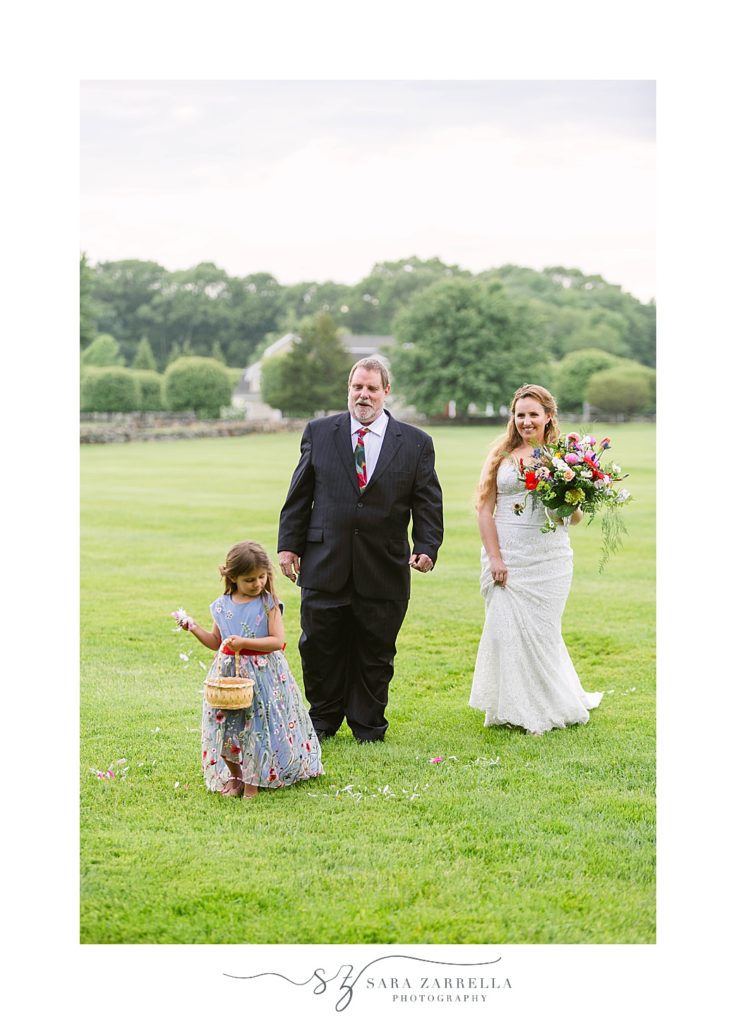 bride walks down the aisle with dad