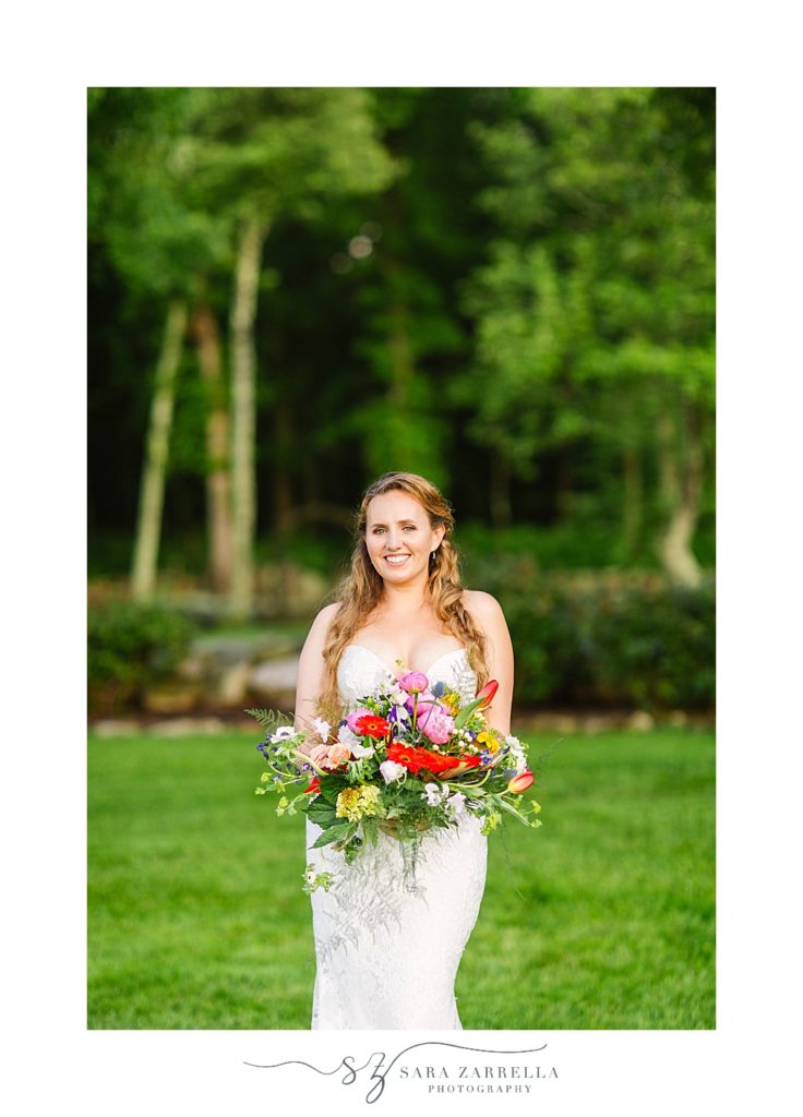bride holds bright wildflower bouquet in Rhode Island