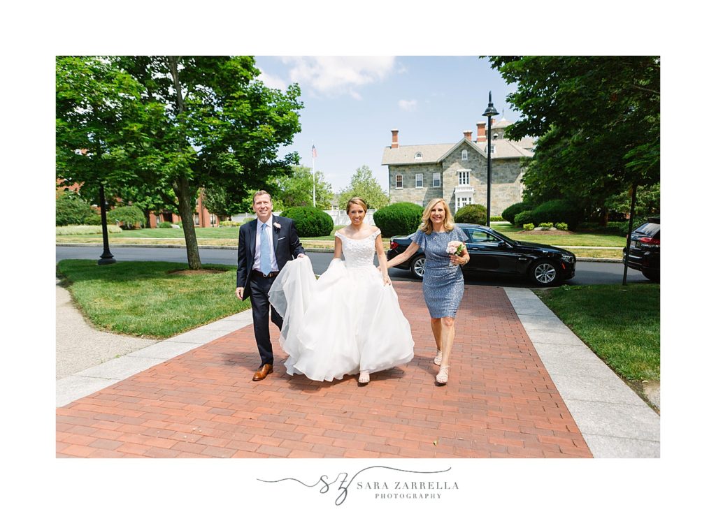 bride and parents walk into Saint Dominic Chapel at Providence College