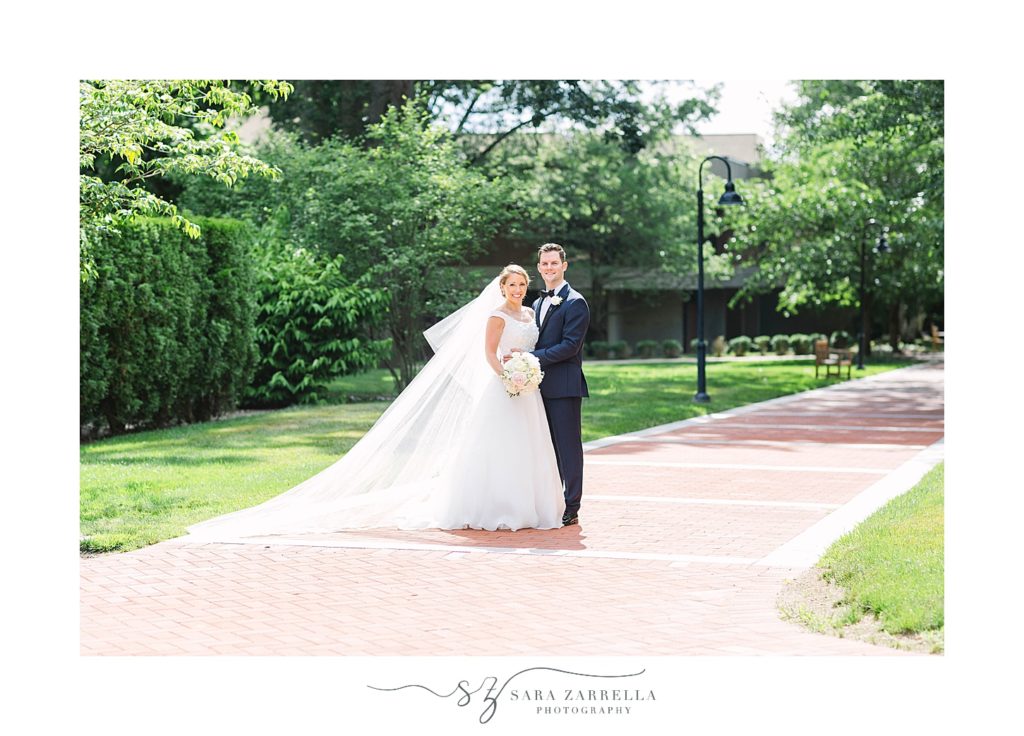 bride and groom pose during Providence College wedding