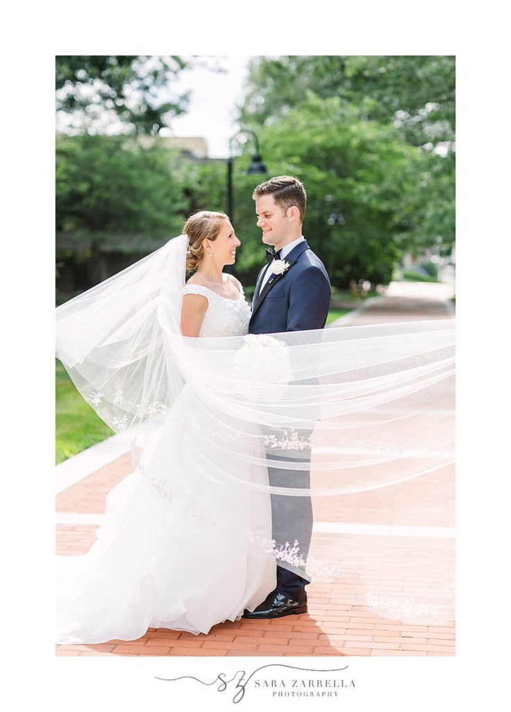 bride and groom portraits with bride's veil in the wind