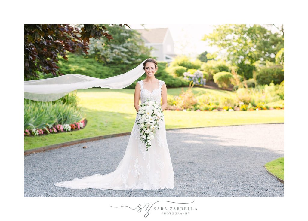portrait of bride with veil flowing in front of Newport RI home