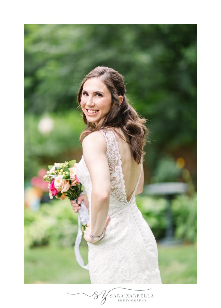 bride looks over shoulder during relaxed backyard wedding portraits