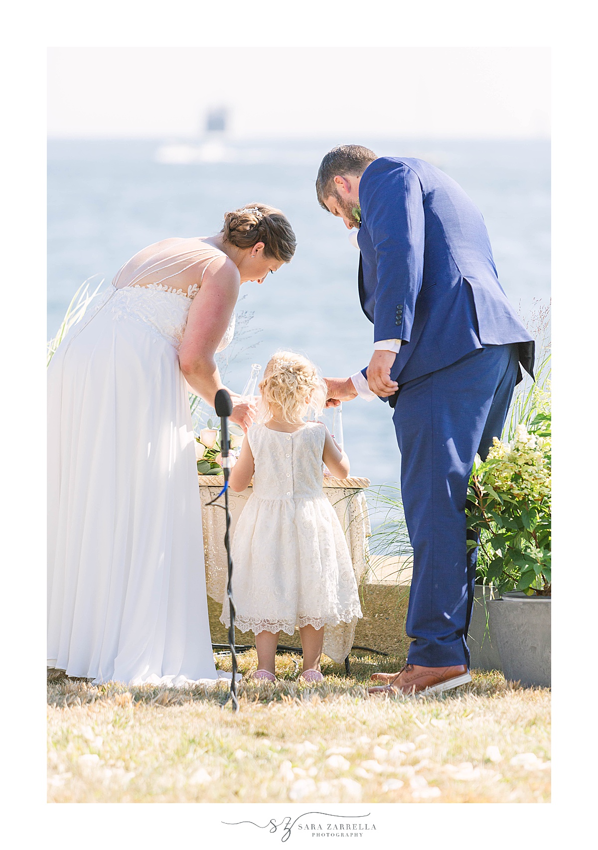 family creates sand display during wedding ceremony