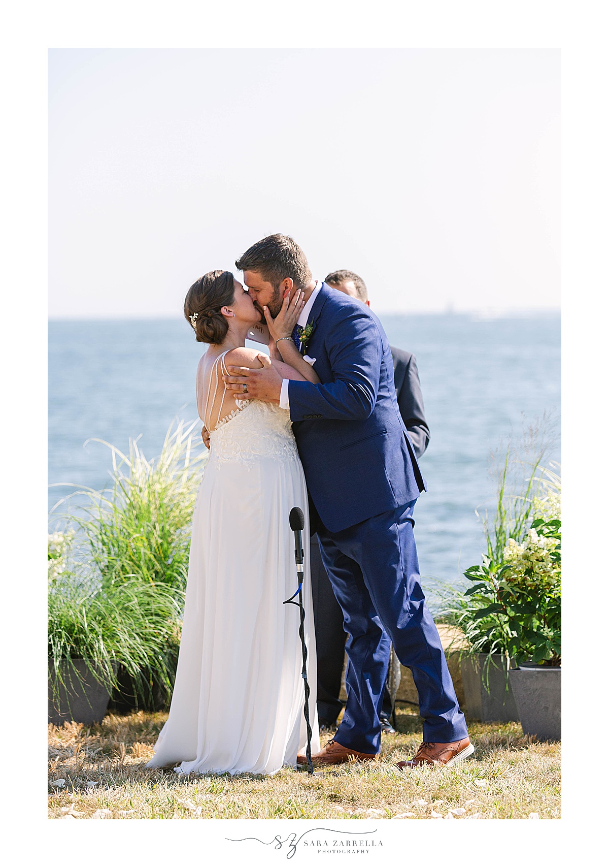 bride and groom kiss after waterfront ceremony