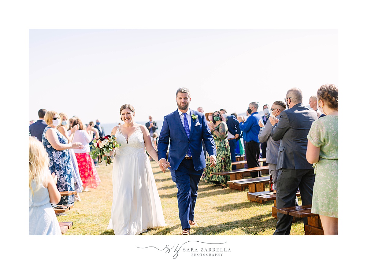 bride and groom walk up aisle after waterfront estate wedding ceremony
