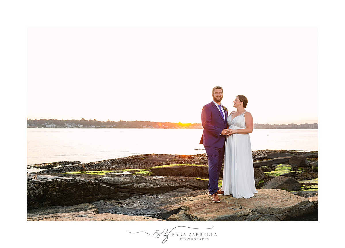 newlyweds stand on rocks for wedding portraits in New England