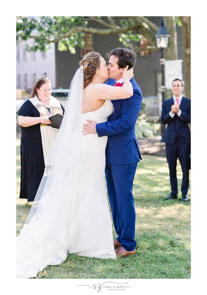 bride and groom kiss during Thames Street wedding ceremony