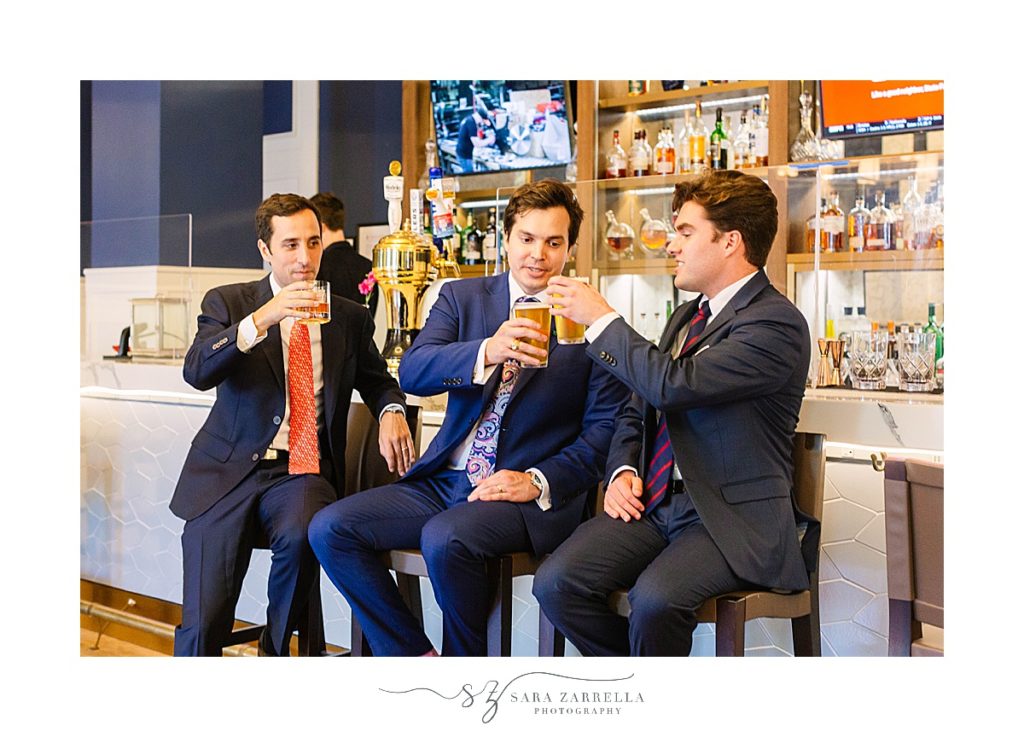 groom toasts beer with friends in Newport RI