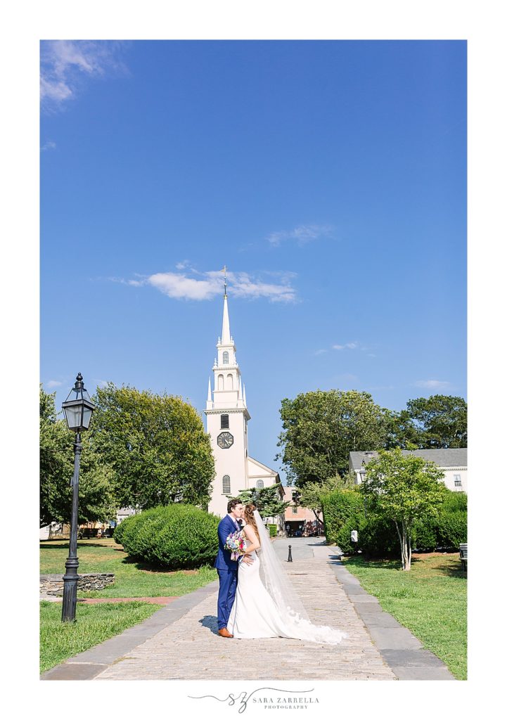bride and groom kiss in front of Newport RI church