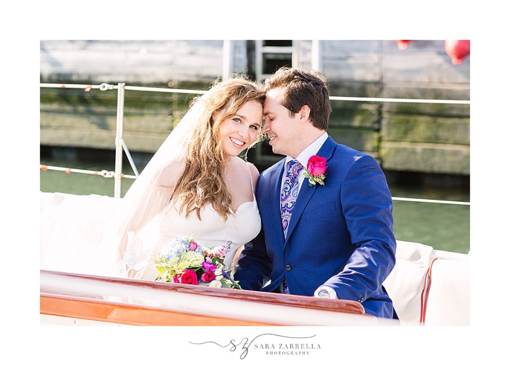 newlyweds sit on sailboat before cruise in Newport RI