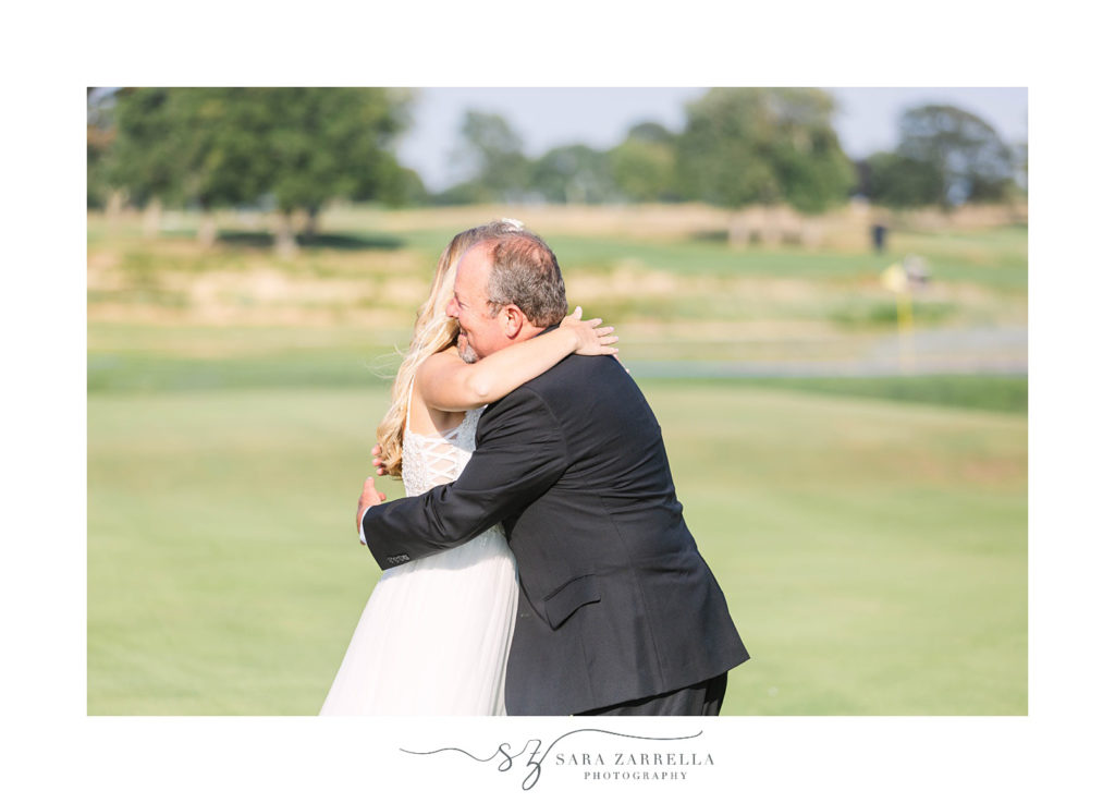 bride hugs dad during first look at Warwick Country Club