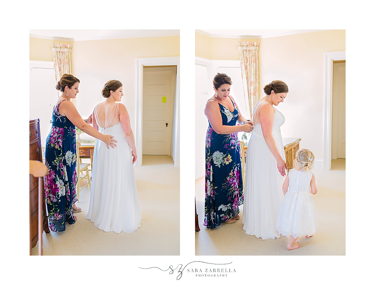 bridesmaid and bride's daughter help with wedding dress