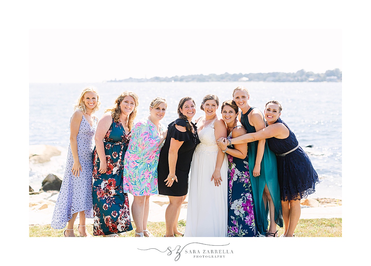 bride poses with bridesmaids on wedding day