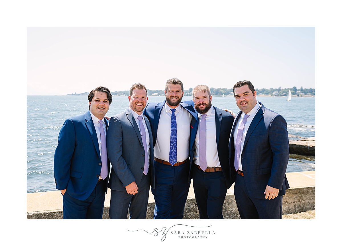 groom poses with groomsmen in Groton CT