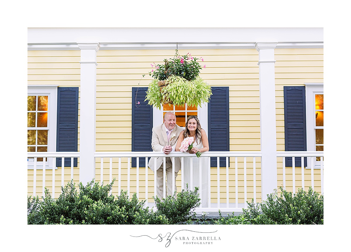 bride and groom pose on balcony at Agawam Hunt Country Club