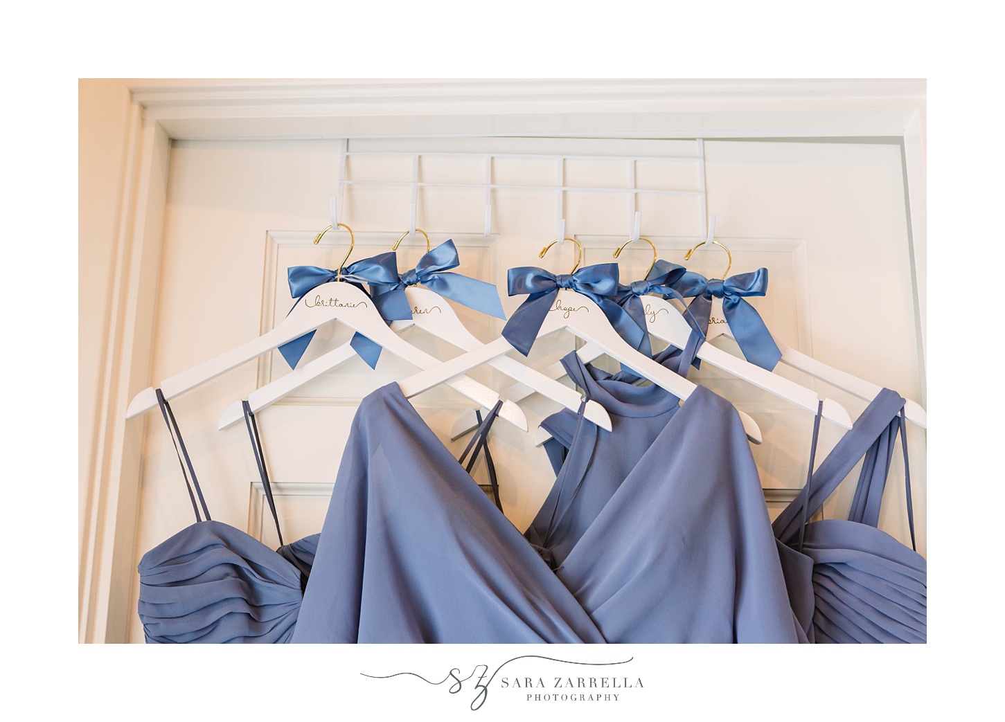 bridesmaids dresses in pale blue hang on closet