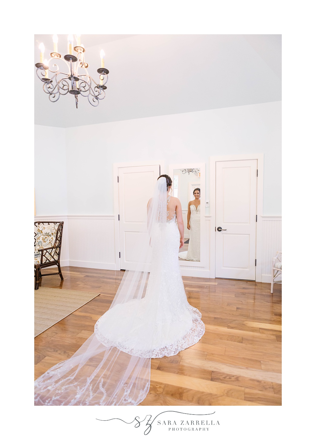 bride looks at reflection in mirror before Blithewold Mansion Wedding