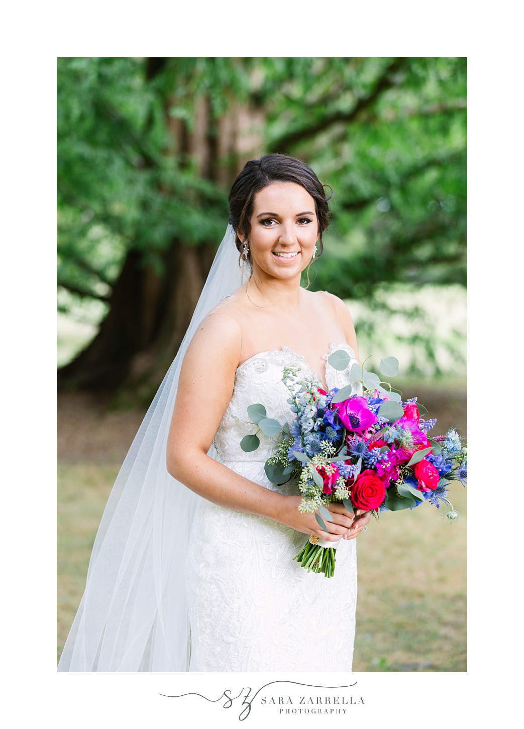 Blithewold Mansion bridal portraits with bride holding bright pink and purple bouquet