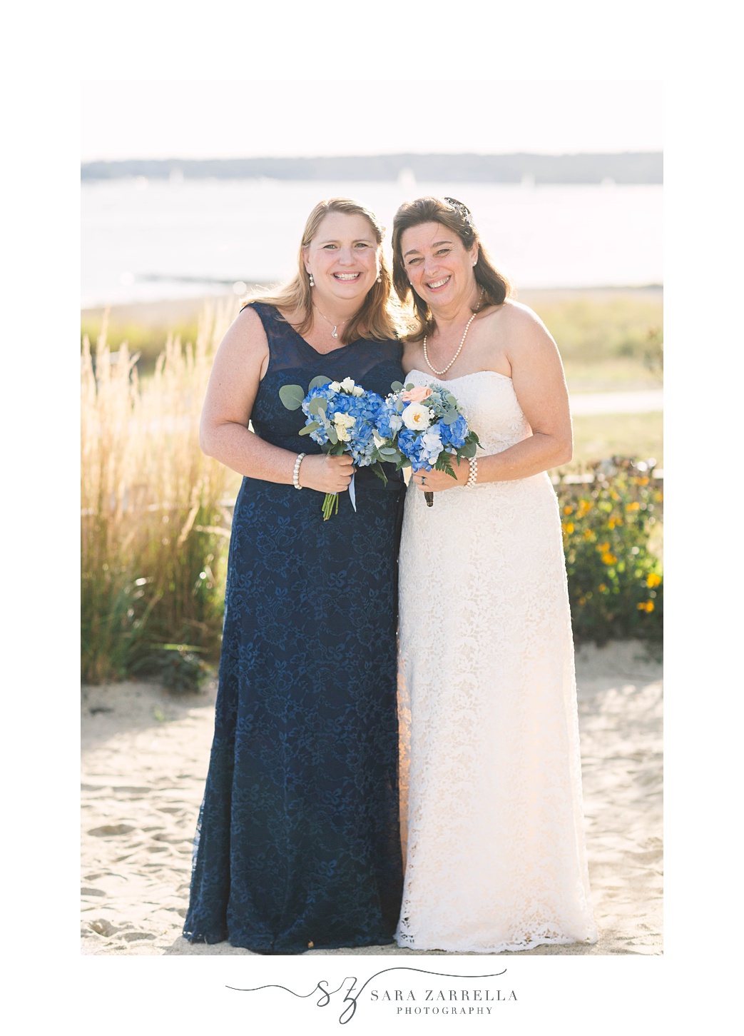 bride poses with maid of honor