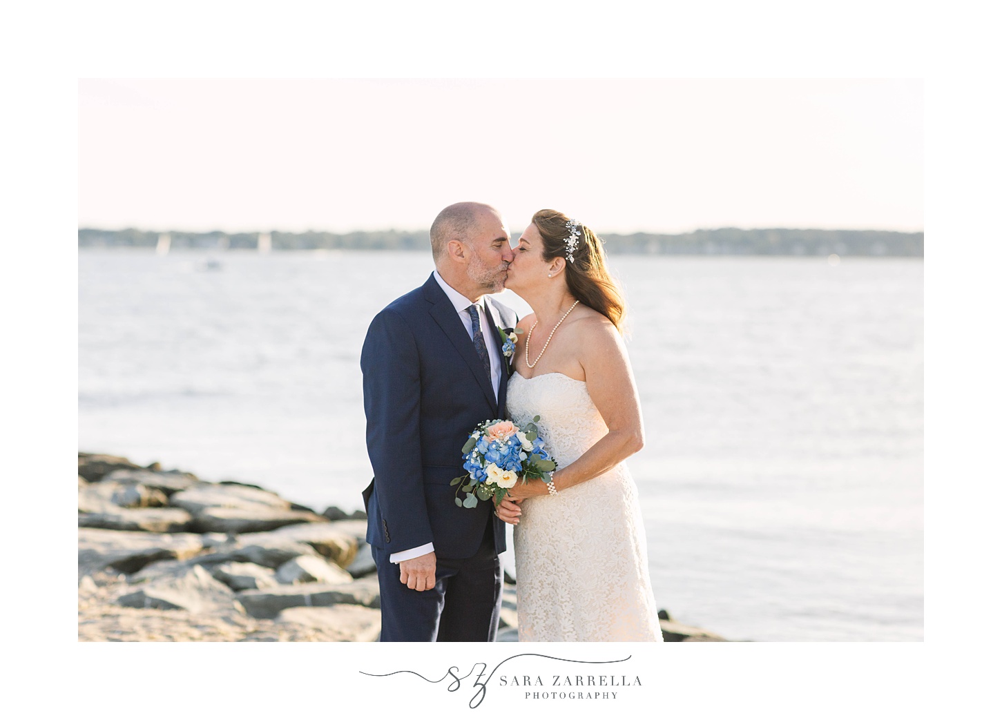 Rhode Island wedding portraits on the beach of bride and groom kissing