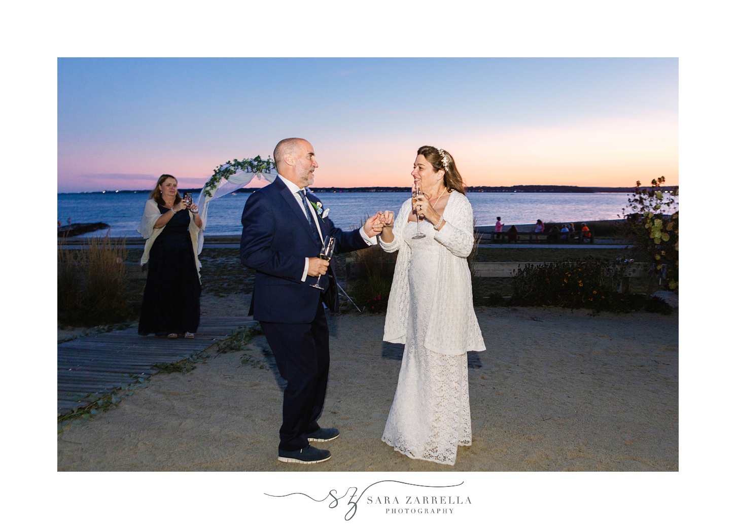 newlyweds dance on beach during wedding reception