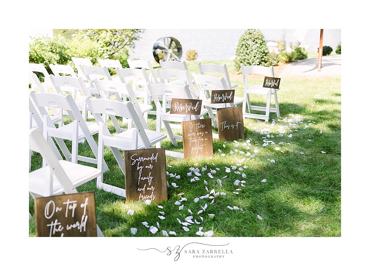 wooden signs for romantic lakeside wedding ceremony seating
