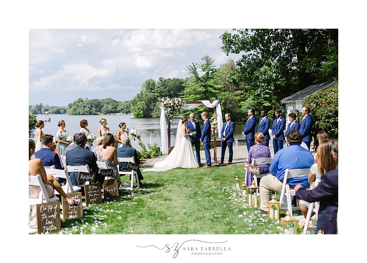 bride and groom exchange vows in romantic lakeside wedding ceremony