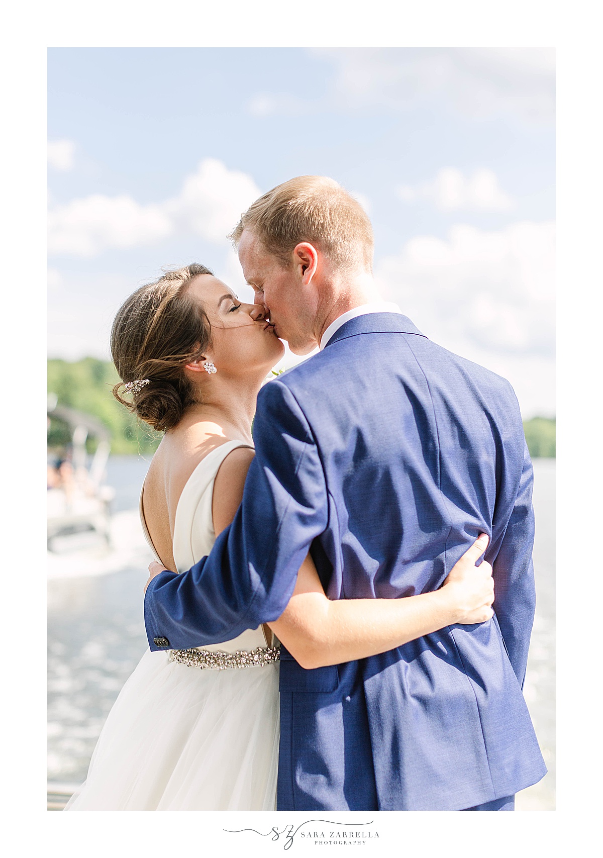newlyweds kiss after lakeside wedding