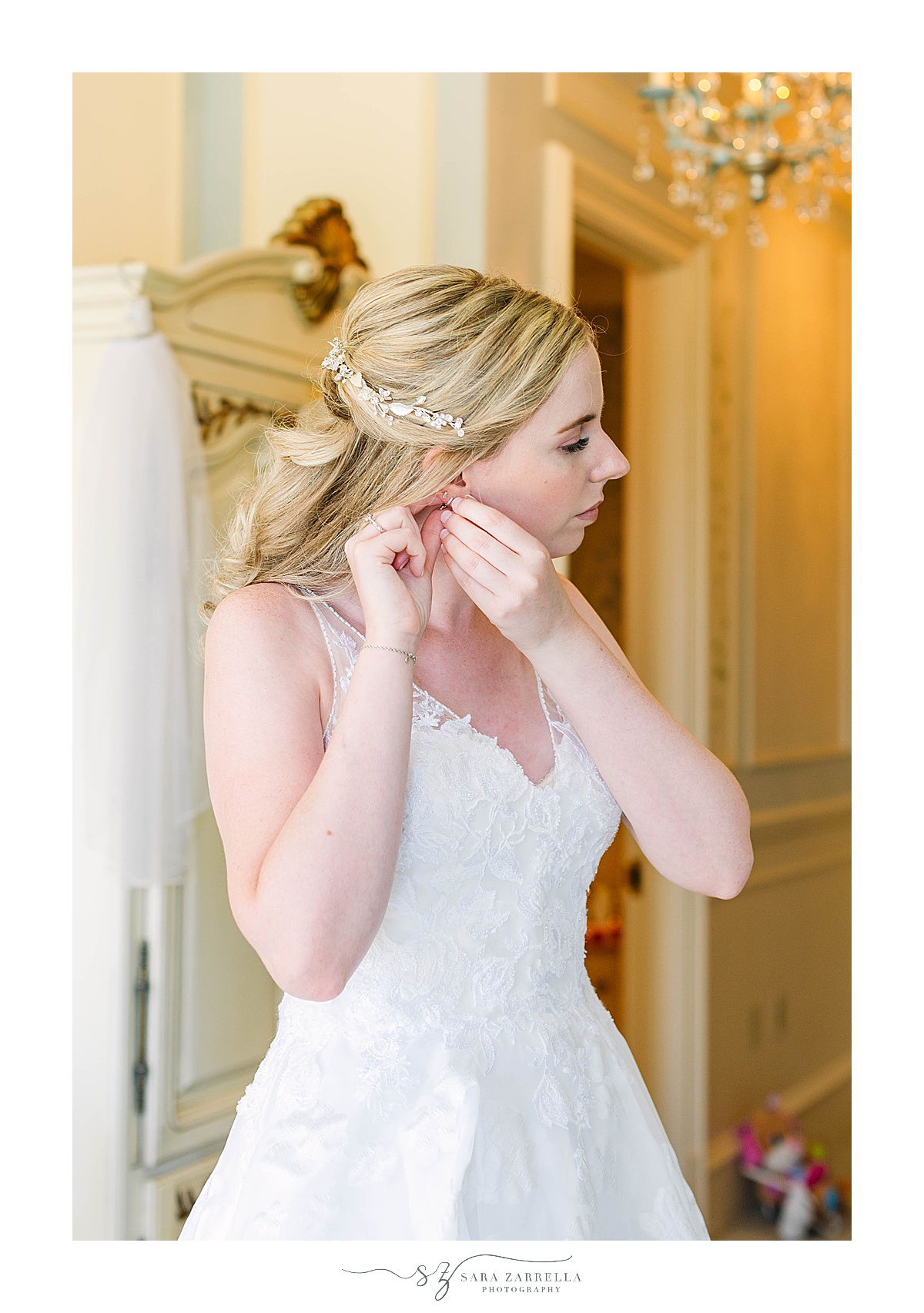 bride adjusts earrings before RI wedding