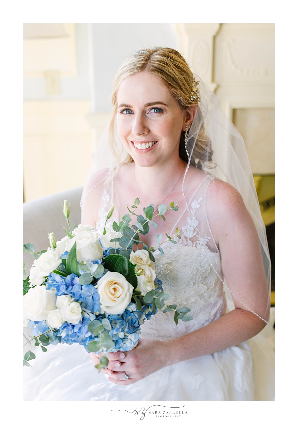 The Chanler at Cliff Walk bridal portraits with bride holding bouquet of blue and white flowers
