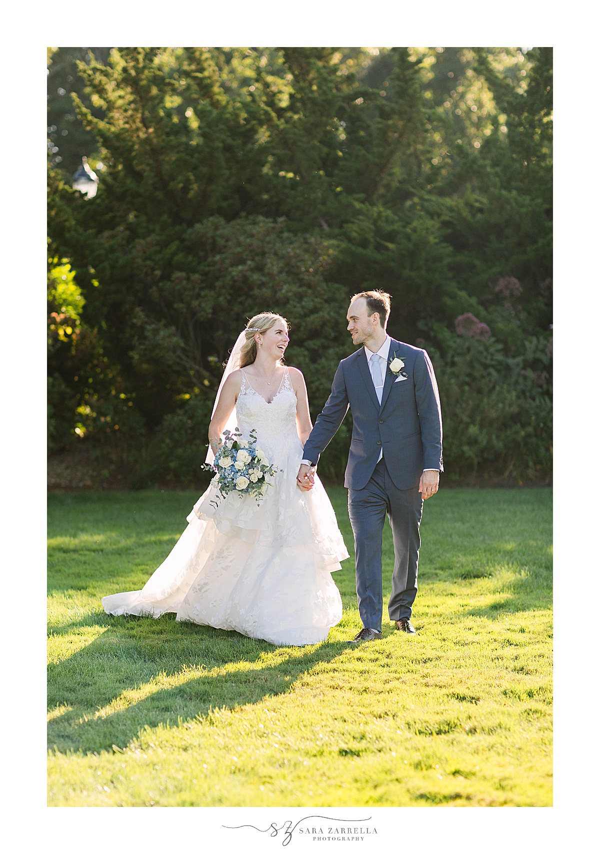 bride and groom walk along The Chanler at Cliff Walk
