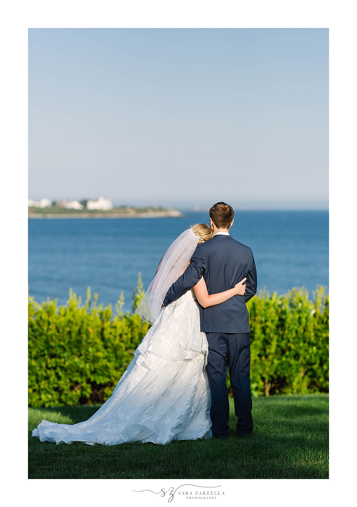 bride and groom stand overlooking Bay