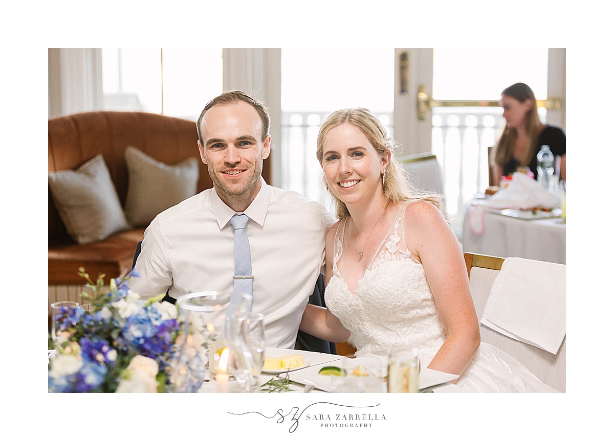bride and groom smile at sweetheart table