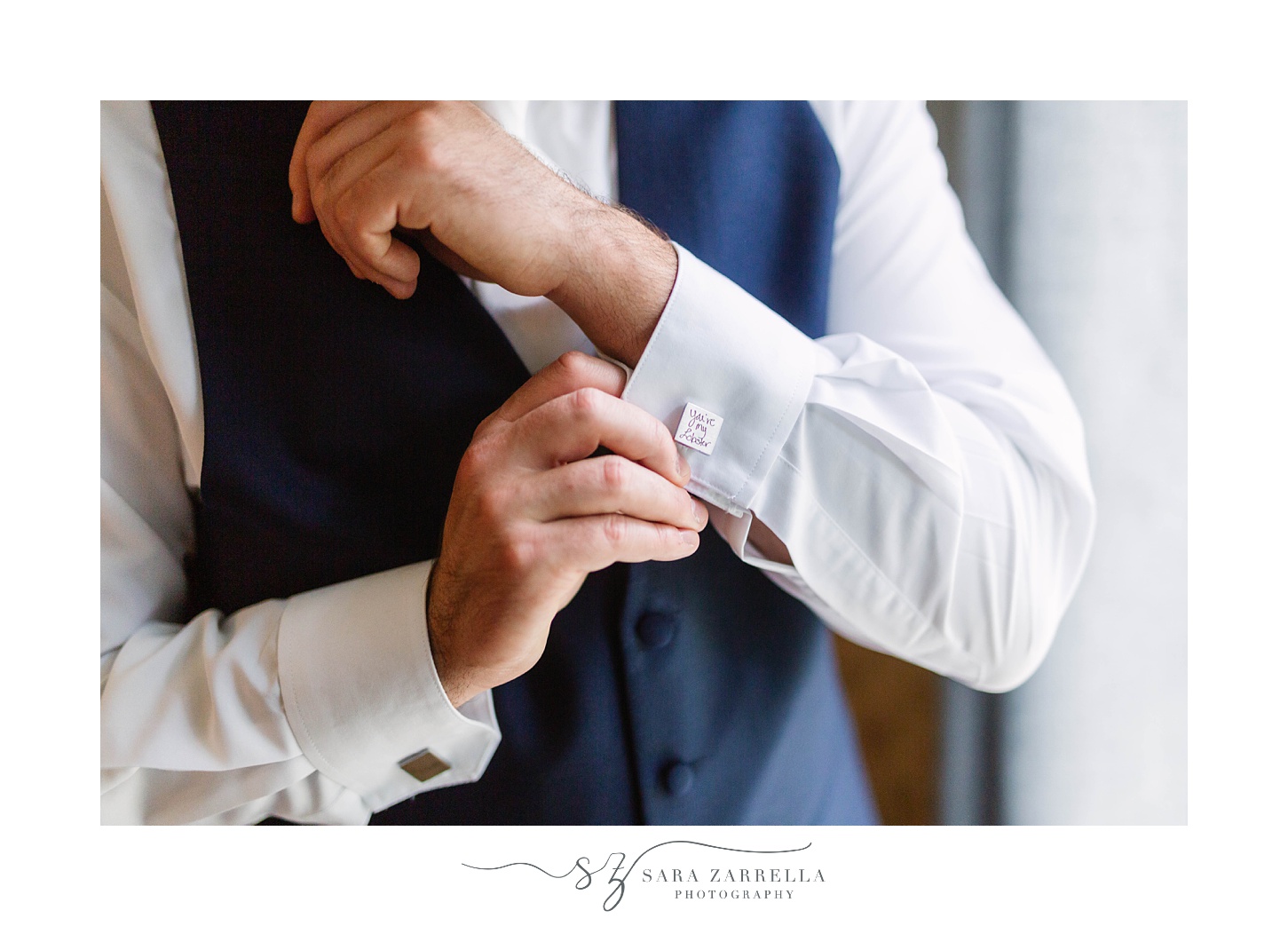 groom adjusts cufflinks for Rhode Island wedding day