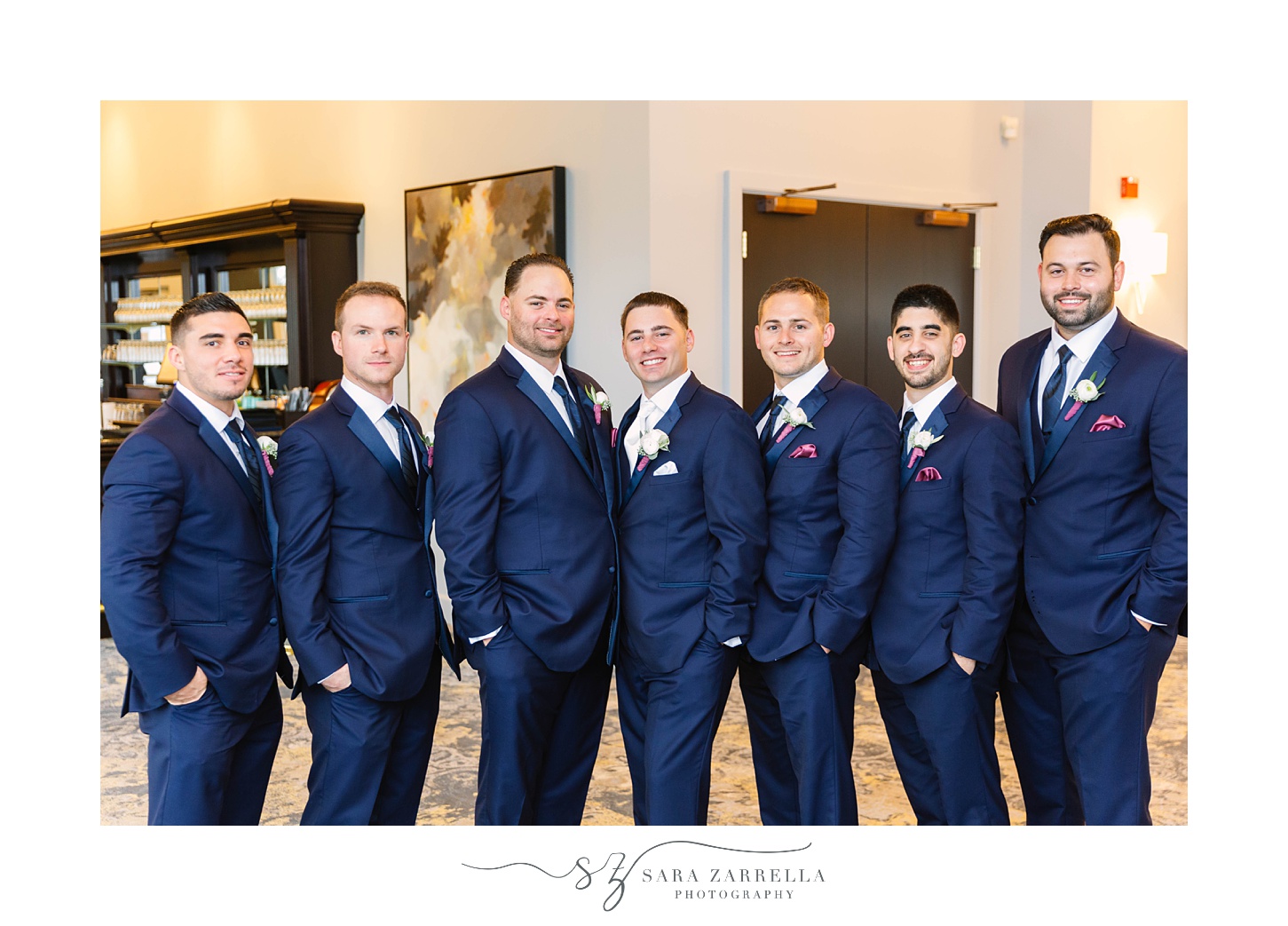 groom and groomsmen pose in navy suits