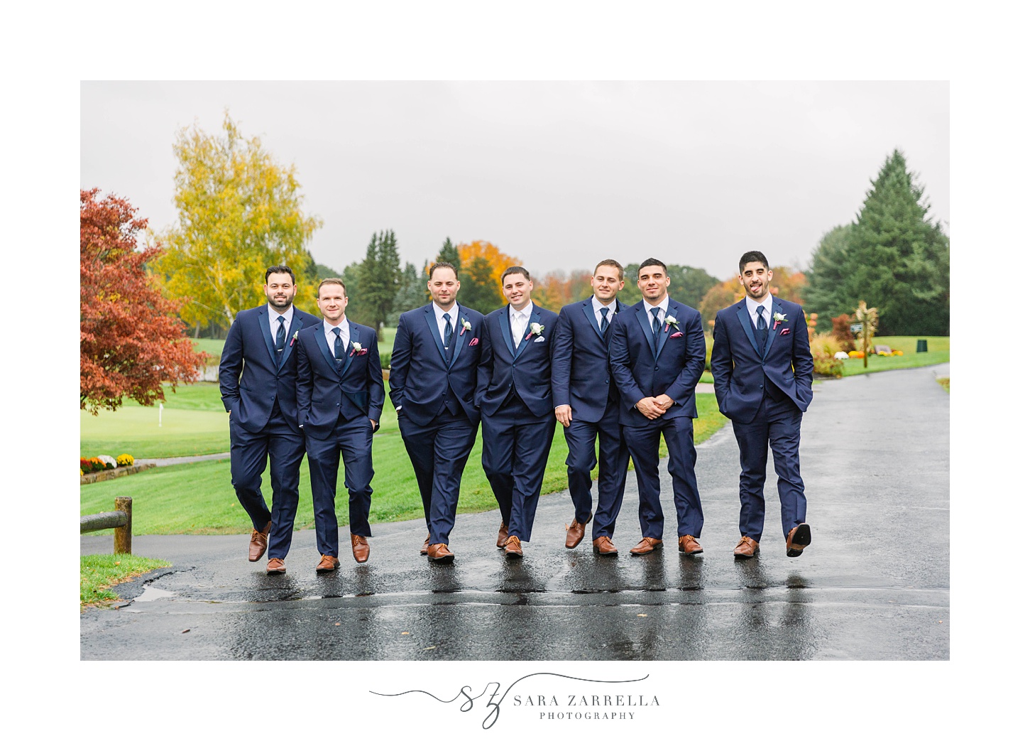 groomsmen walk outside Kirkbrae Country Club on rainy wedding day