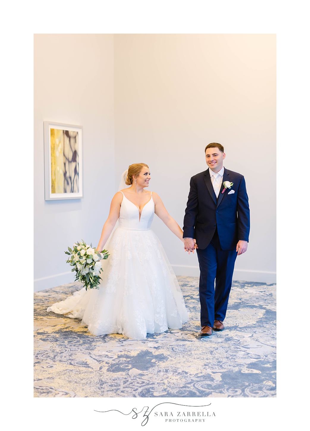 newlyweds walk together during Rhode Island wedding photos