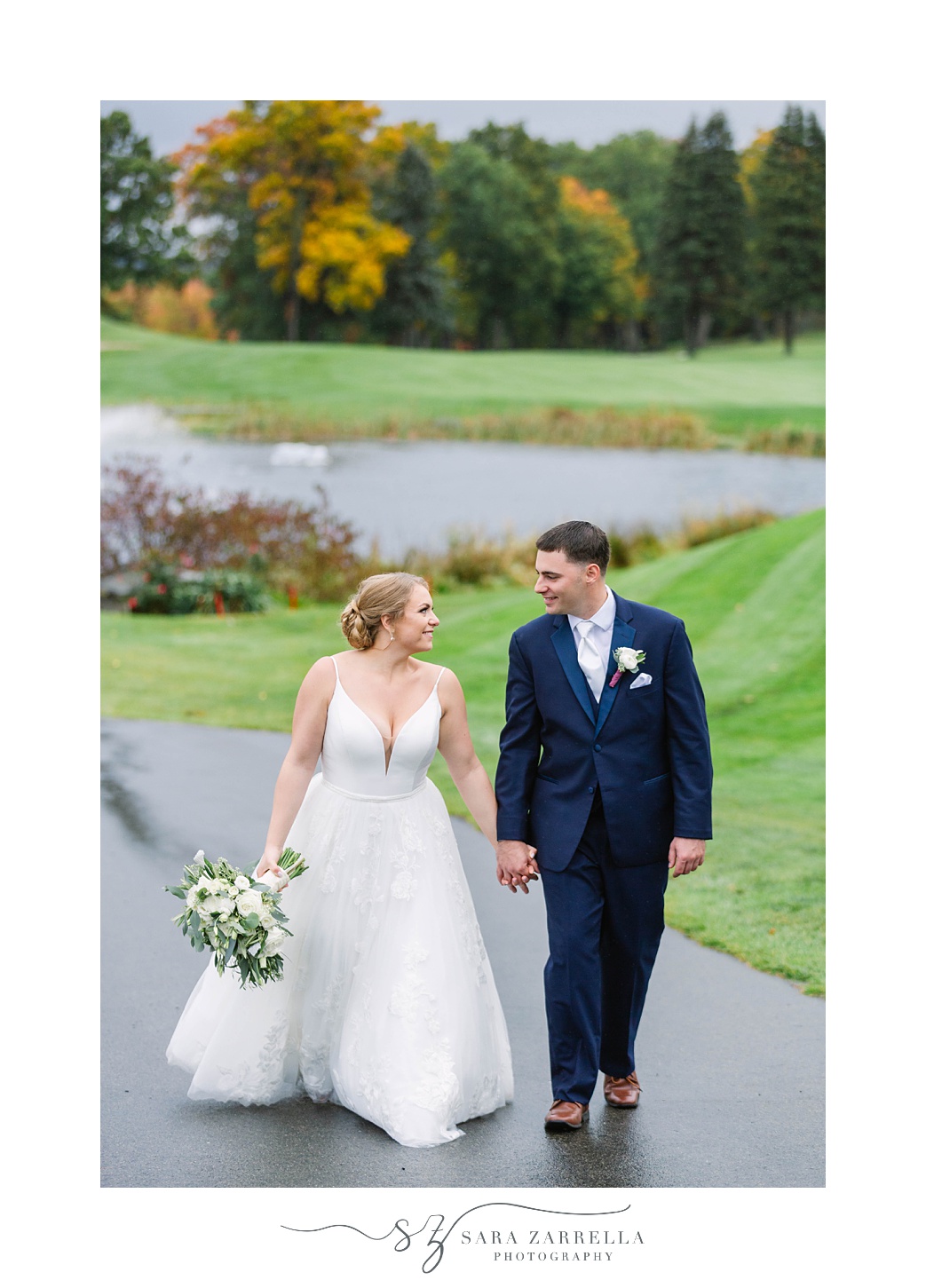 bride and groom hold hands walking through Kirkbrae Country Club