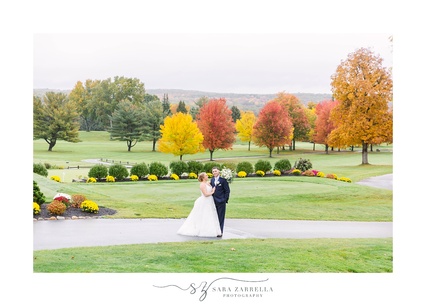 bride and groom pose at Kirkbrae Country Club in front of trees
