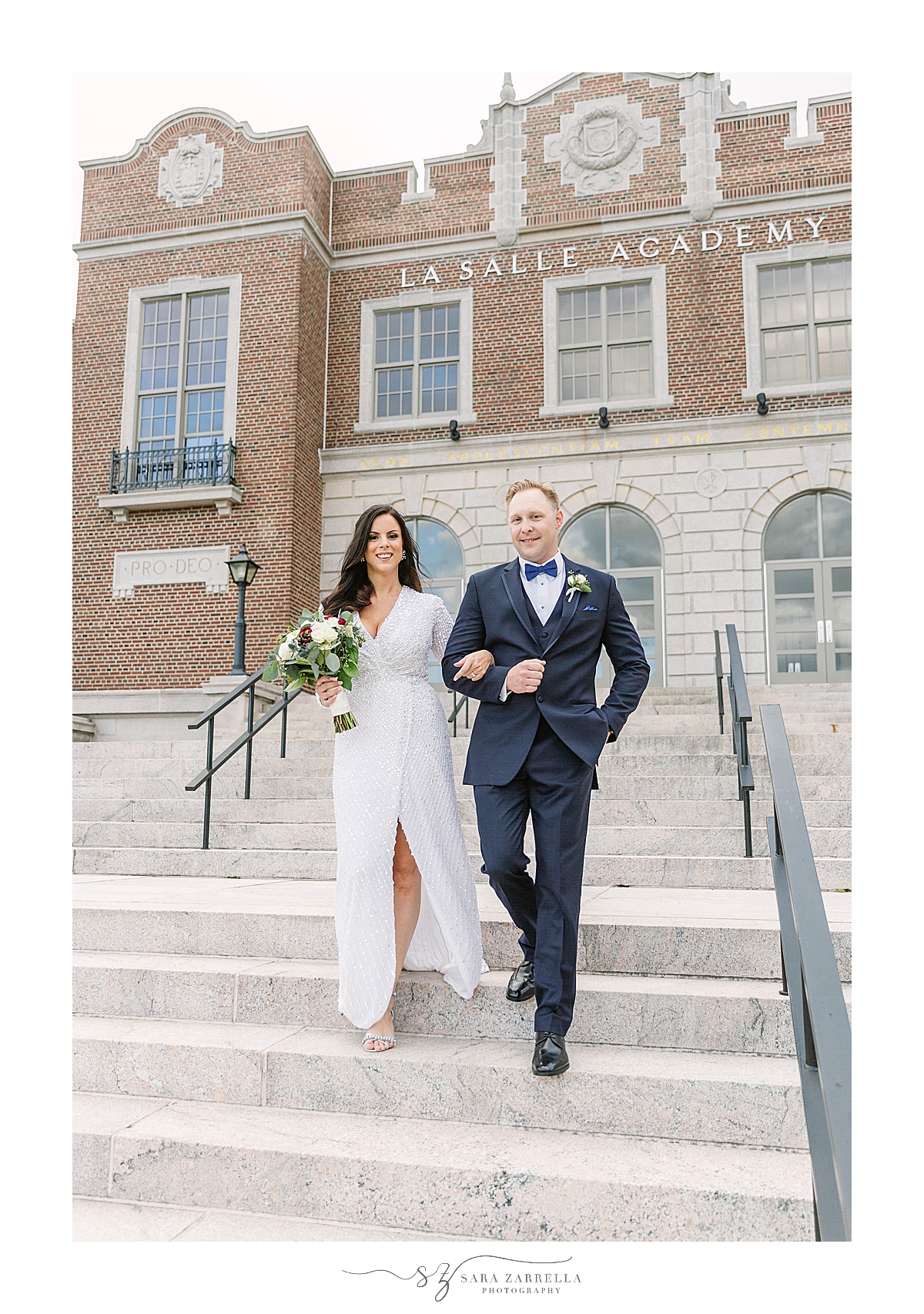bride and groom walk down steps in Rhode Island