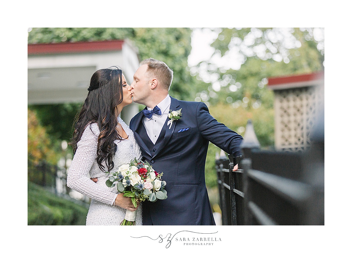 bride and groom kiss at La Salle Academy Chapel