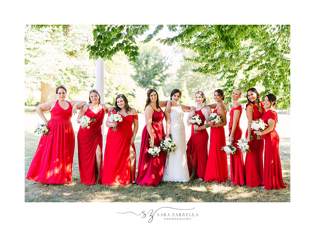 bride poses with bridesmaids in Rhode Island